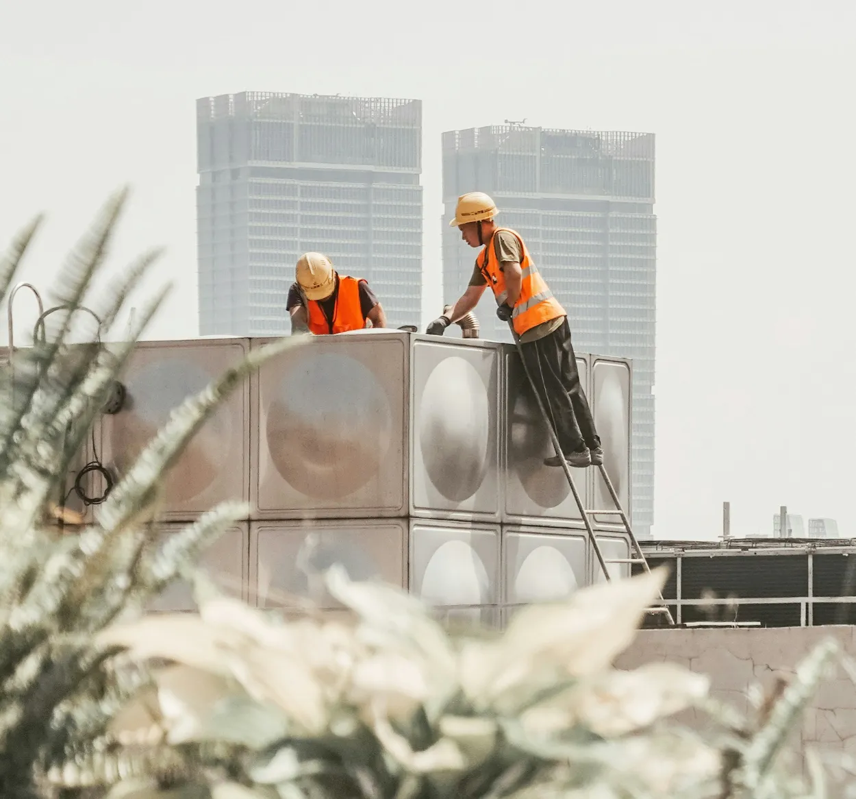Technicians repairing a commercial A/C unit